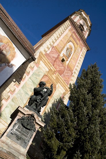 GERMANY, Bavaria, Mittenwald, "Pfarrkirche St Peter and Paul. Bell tower with statue of Mathias Klotz, founder of the violin industry.  "