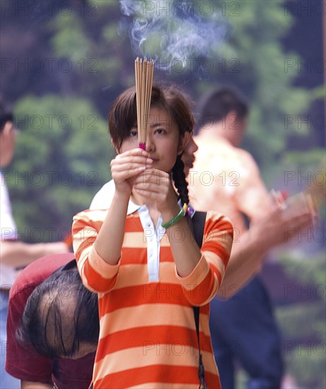 CHINA, Zhejiang , Putuoshan, Burning incense at Puji Temple