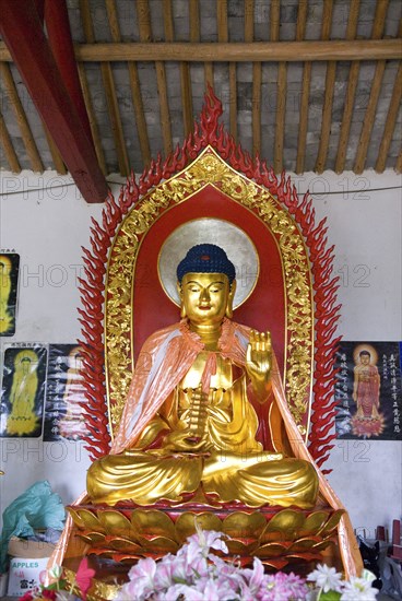 CHINA,  Zhejiang, Zhoushan, Buddha at Seven Stars Temple a poor temple