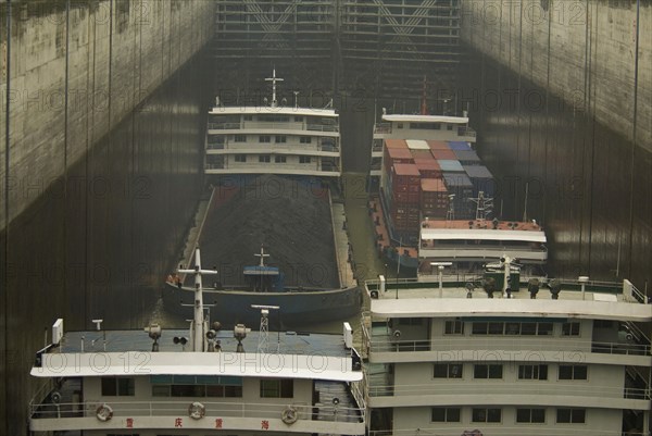 CHINA, Hubei , Sandouping, River traffic including coal barge and containers in the locks of the Three Gorges Dam at Sandouping