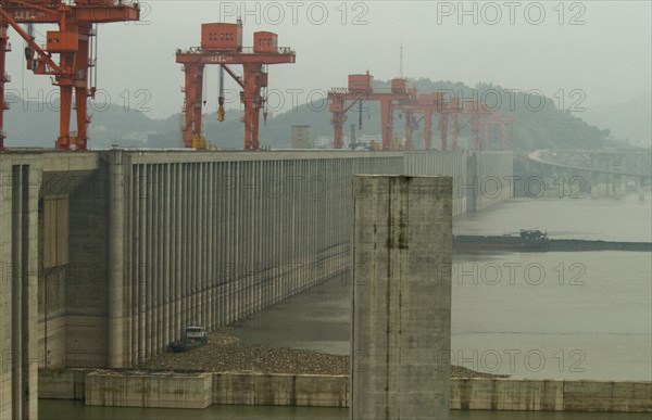 CHINA, Hubei , Sandouping, The Three Gorges Dam at Sandouping - the scale can be seen from the beached barge in the foreground