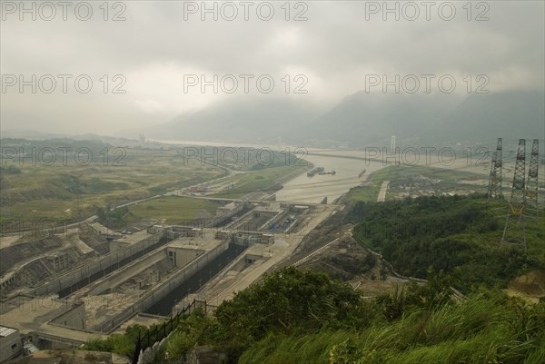 CHINA, Hubei , Sandouping, Hydro-electric pylons and the east bound locks at the Three Gorges Dam project on the Yangtze River at Sandouping. Power generation increased river trade and flood control are the main objectives of the project due for completion in 2009