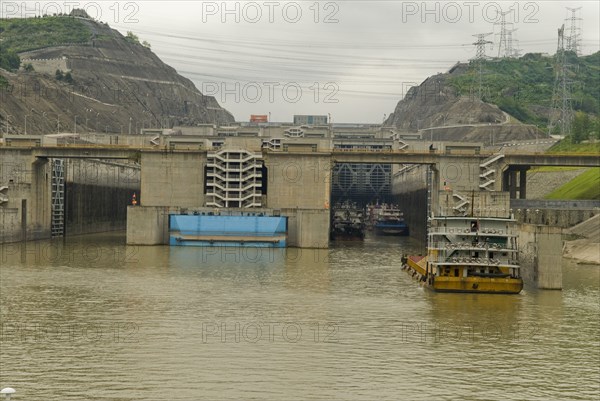 CHINA, Hubei , Sandouping, Sand barge approaching the westbound 5 step locks at the Three Gorges Dam on the Yangtze River at Sandouping