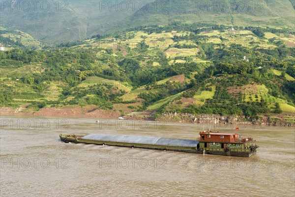 CHINA, Chongqing , Wushan , Barge on the Yangtze River near Wushan passing rich farmland