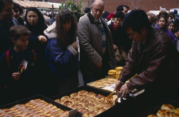 ENGLAND, London, Chinese New Year, "Food stall during Chinese New Year celebrations in Chinatown, Soho.   Diverse, racially mixed crowd."