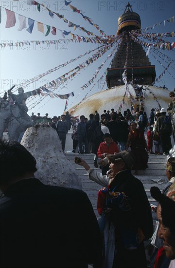 NEPAL, Kathmandu, Bodhanath, Crowd of Tibetans offering incense on the steps of the main stupa during New Year celebrations.