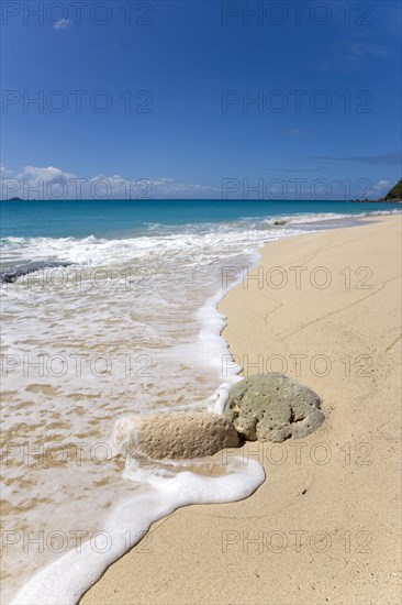 WEST INDIES, St Vincent And The Grenadines, Canouan, South Glossy Beach in Glossy Bay with waves breaking on the shoreline of the turqoise sea and yachts on the horizon