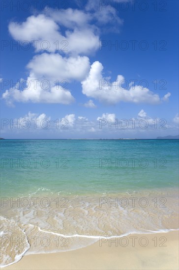 WEST INDIES, Grenada, Carriacou, Waves breaking on Paradise Beach at L'Esterre Bay with the turqoise sea and Sandy Island sand bar beyond