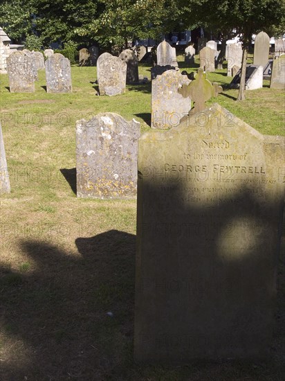 ENGLAND, West Sussex, Shoreham-by-Sea, Weather worn headstones in the cemetery of the Church os St Mary de Haura.