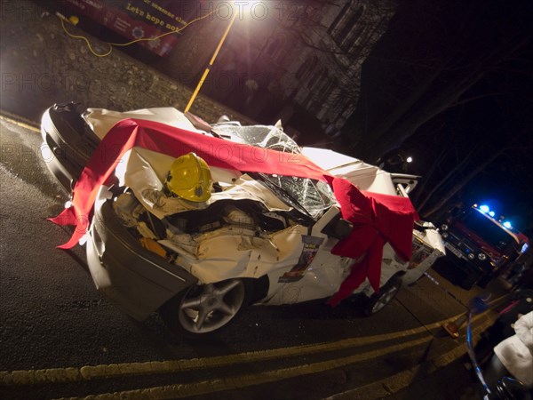 TRANSPORT, Road, Cars, Wrecked car wrapped in red bow as part of a police anti Drink Drive campaign for the Christmas period.