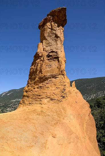 FRANCE, Provence Cote d’Azur, Vaucluse, "Colorado Provencal.  Cheminee de Fee or Fairy Chimneys.  Dramatic, capped, ochre rock pinnacle."