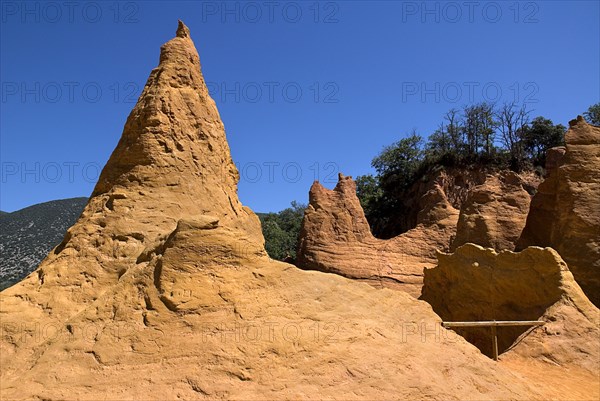 FRANCE, Provence Cote d’Azur, Vaucluse, Colorado Provencal.  Cheminee de Fee or Fairy Chimneys.  General view from summit of eroded ochre rock cliff and peaks.