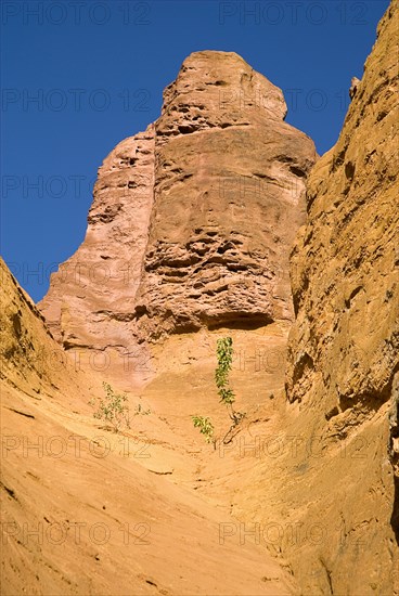 FRANCE, Provence Cote d’Azur, Vaucluse, Colorado Provencal.  Cheminee de Fee or Fairy Chimneys.  View of eroded ochre rock form from the park trail.