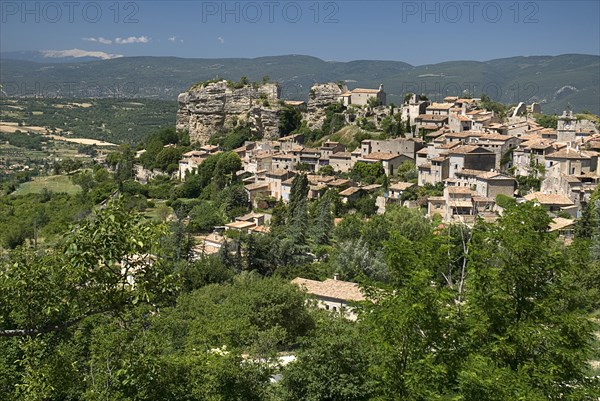 FRANCE, Provence Cote d’Azur, Vaucluse, "Saignon.  Provencal hilltop village with Mont Ventoux seen in the distance, top left."