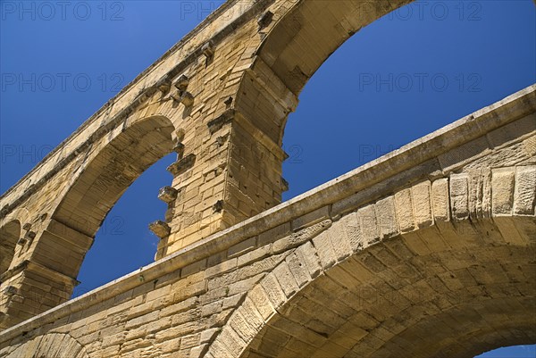 FRANCE, Provence Cote d’Azur, Gard, Pont du Gard.  Close up detail of section of tiered arches of Roman aqueduct.