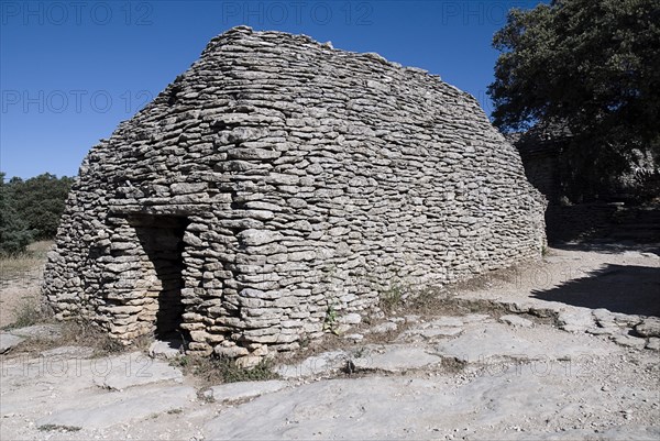 FRANCE, Provence Cote d’Azur, Vaucluse, "Le Village des Bories.  Abandoned primitive village near Gordes comprising of small huts made from overlapping stone, each with a specific function."