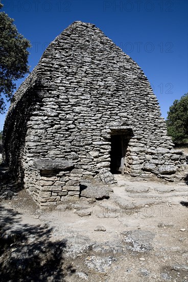 FRANCE, Provence Cote d’Azur, Vaucluse, "Le Village des Bories.  Ancient village comprising of mortarless stone, beehive shaped huts or bories, each with a specific function such as the barn pictured. The village was restored in 1976"