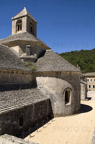 FRANCE, Provence Cote d’Azur, Vaucluse, Abbaye Notre Dame de Senanque.  Exterior view of chapel and courtyard of twelth century Cistercian monastery.  Known as one of the Three Sisters of Provence together with the Romanesque and Silvacane abbeys.
