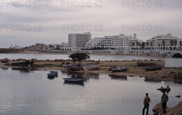 TUNISIA, Monastir, Hotels viewed from marina across beach and harbour.