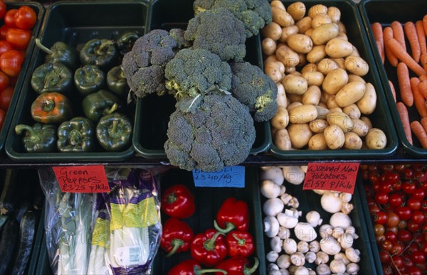 ENGLAND, East Sussex, Hastings, Vegetables in trays outside greengrocers shop.