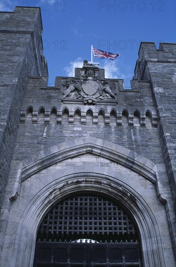 ENGLAND, West Sussex, Arundel, Arundel Castle. Part view of the entrance gate and crenelated towers with Union Jack flag flying above.