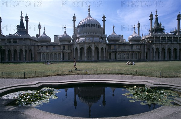 ENGLAND, East Sussex, Brighton, The Royal Pavilion exterior seen from across lilly pond.