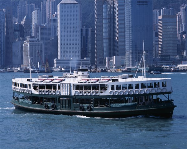 CHINA, Hong Kong, Victoria Harbour, "Star Ferry crossing Victoria Harbour, high rise city buildings part seen behind."