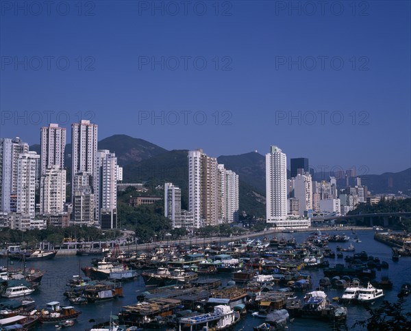 CHINA, Hong Kong, Aberdeen, "Aberdeen harbour and typhoon shelter.  Junks, houseboats, fishing boats and other vessels with high rise city buildings beyond."
