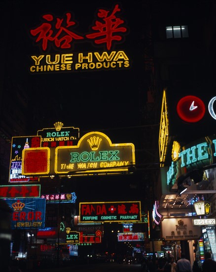 CHINA, Hong Kong, Kowloon, Illuminated advertising hoarding and neon signs on busy Nathan Road at night.