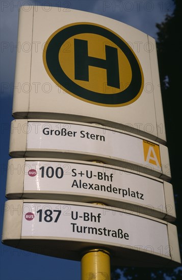 GERMANY, Berlin, Bus and tram stop sign  green H within yellow circle stands for Haltestelle or stopping point.