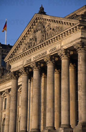 GERMANY, Berlin, The Reichstag  seat of German Parliament.  Part view of colonnaded exterior designed by Paul Wallot 1884-1894.  To The German People inscribed above entrance .