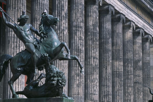 GERMANY, Berlin, Bronze equestrian statue entitled The Lion Fighter by Albert Wolf in 1847 outside colonnaded facade of the Altes Museum designed by Karl Friedrich Schinkel.