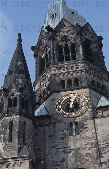 GERMANY, Berlin, Kaiser Wilhelm Memorial Church. Part view of ruined gothic exterior with clock face.  The original church was partly destroyed during a 1943 bombing raid.