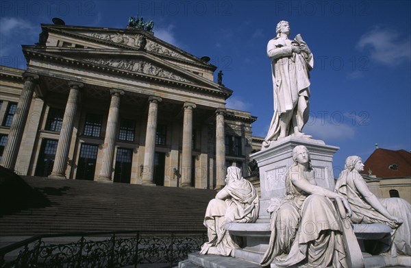 GERMANY, Berlin, The Friedrich Schiller Memorial statue by Reinhold Begas in front of the former Schauspielhaus  now Konzerthaus home of the Berlin Symphony Orchestra.