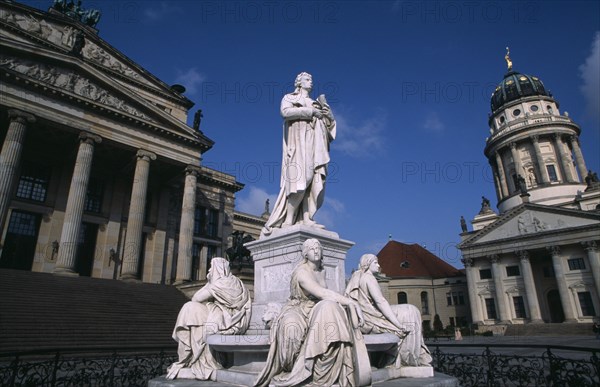 GERMANY, Berlin, The Friedrich Schiller Memorial statue by Reinhold Begas in front of the Konzerthaus home of the Berlin Symphony Orchestra with Franzosischer Dom part seen on right.