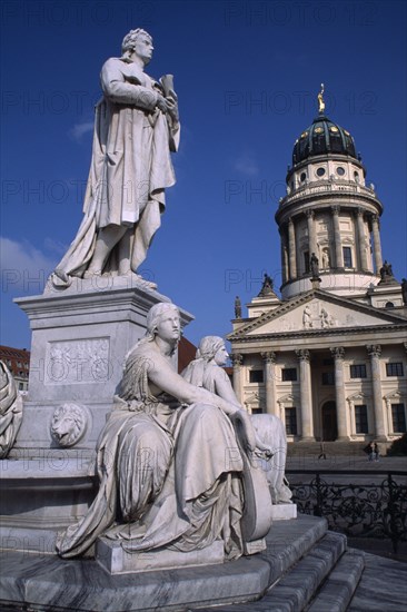 GERMANY, Berlin, The Friedrich Schiller Memorial statue by Reinhold Begas in front of the Konzerthaus home of the Berlin Symphony Orchestra with Franzosischer Dom on right.