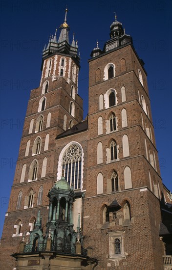 POLAND, Krakow, Mariacki Basilica or Church of St Mary.  Gothic  red brick exterior built in the fourteenth century.