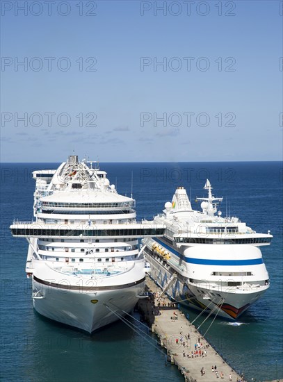 WEST INDIES, Grenada, St George, Two cruise ships the Caribbean Princess and Aida Aura moored at the cruise ship terminal in the capital city of St George's with passengers walking along the jetty between the liners