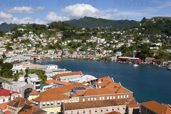 WEST INDIES, Grenada, St George, The Carenage harbour of the capital city of St George's surrounded by hills lined with houses and other buildings