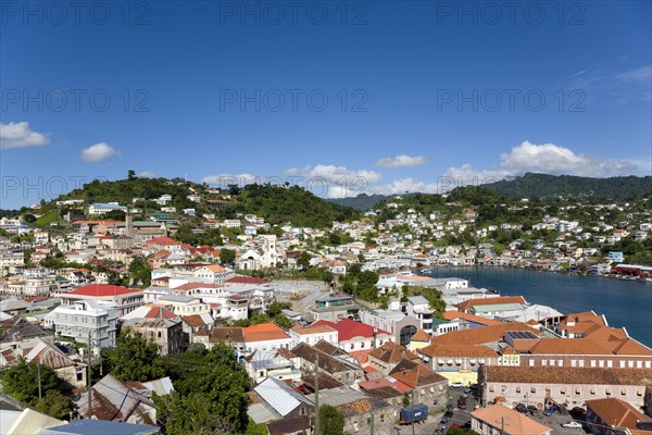 WEST INDIES, Grenada, St George, The Carenage harbour of the capital city of St George's surrounded by hills lined with houses and other buildings