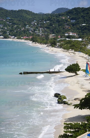 WEST INDIES, Grenada, St George, Waves of the aquamarine sea breaking on the two mile stretch of the white sand Grand Anse Beach