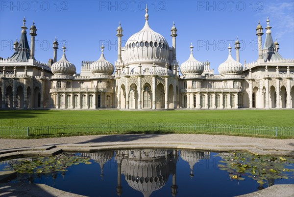 ENGLAND, East Sussex, Brighton, The onion shaped domes of the 19th Century Pavilion designed in the Indo- Saracenic style by John Nash commissioned by George Prince of Wales later to become King George IV. The oval water lilly pond in the foreground