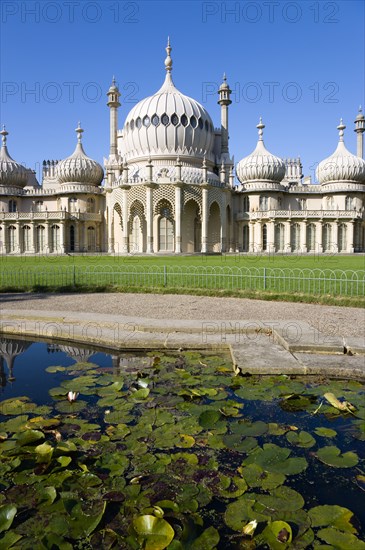 ENGLAND, East Sussex, Brighton, The onion shaped domes of the 19th Century Pavilion designed in the Indo- Saracenic style by John Nash commissioned by George Prince of Wales later to become King George IV. The oval water lilly pond in the foreground