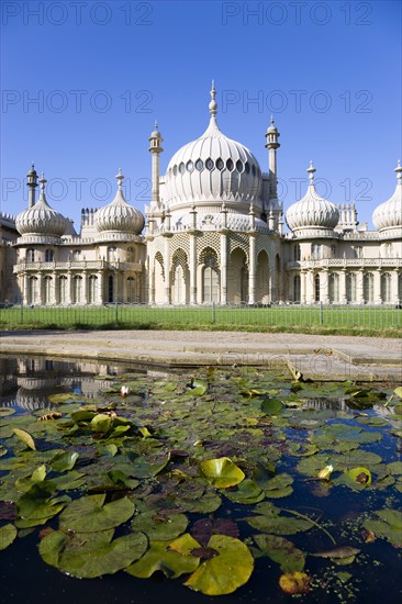 ENGLAND, East Sussex, Brighton, The onion shaped domes of the 19th Century Pavilion designed in the Indo- Saracenic style by John Nash commissioned by George Prince of Wales later to become King George IV. The oval water lilly pond in the foreground