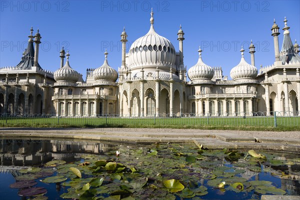 ENGLAND, East Sussex, Brighton, The onion shaped domes of the 19th Century Pavilion designed in the Indo- Saracenic style by John Nash commissioned by George Prince of Wales later to become King George IV. The oval water lilly pond in the foreground