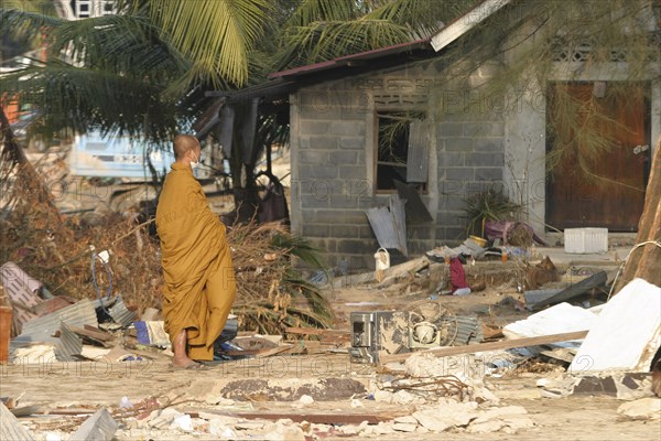 THAILAND, Phang Nga District, Nam Khem, "Tsunami. A Thai Monk looks at the damage caused by the tsunami, nothing is left standing in the village 2500 people are pressumed dead. 125kms north of Phuket on the 2nd Jan."