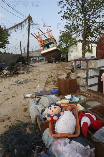 THAILAND, Phang Nga District, Nam Khem, "Tsunami. Childrens toys ly piled up and Boats have been pushed onto the streets which have also been damaged in the village, nothing is left standing in the village  2500 people are pressumed dead 125kms north of Phuket on the 2nd Jan"