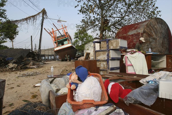 THAILAND, Phang Nga District, Nam Khem, "Tsunami. Childrens toys ly piled up and Boats have been pushed onto the streets which have also been damaged in the village, nothing is left standing in the village  2500 people are pressumed dead 125kms north of Phuket on the 2nd Jan"