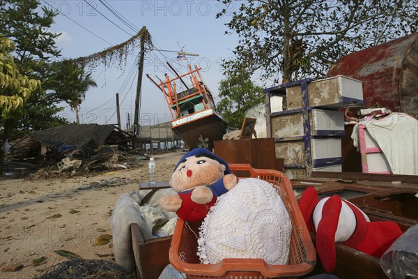 THAILAND, Phang Nga District, Nam Khem, "Tsunami. Childrens toys ly piled up and Boats have been pushed onto the streets which have also been damaged in the village, nothing is left standing in the village  2500 people are pressumed dead 125kms north of Phuket on the 2nd Jan"