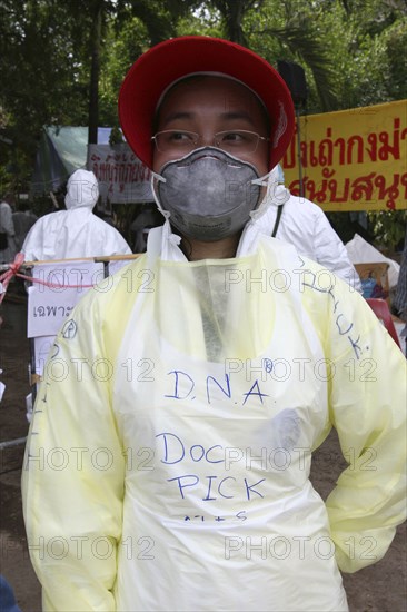 THAILAND, Phang Nga District, Takua Pa, "Tsunami. Forensic people and volunteers have to wear masks and suits to work in the area where the bodies are kept for DNA testing for the sanitation, They are also sprayed down when leaving the area. At the temple Wat Yan Yao."